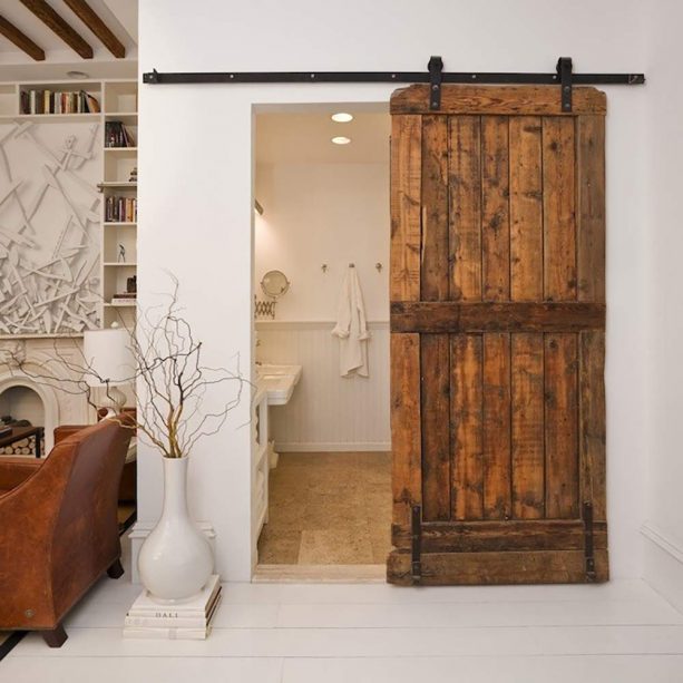 a public bathroom barn door in an eclectic living room