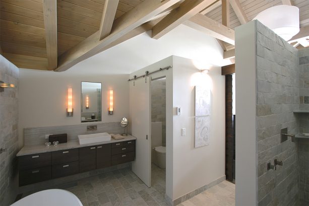a sliding barn door for covering a small toilet in a contemporary bathroom