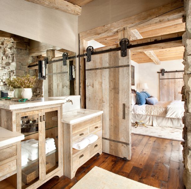 a wooden barn door with stunning wheels and hangers in a rustic interior