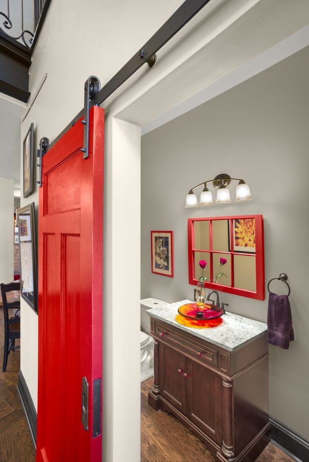 bright red contemporary barn bathroom door with black track and hardware