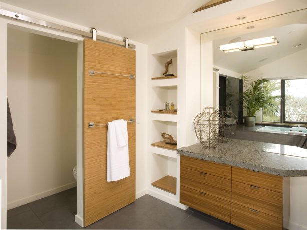 contemporary bathroom barn door with towel hangers