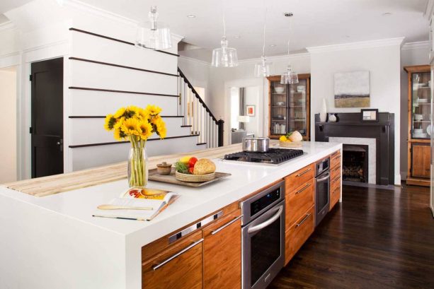 a contemporary kitchen with dark wood floor and custom white island with cabinets