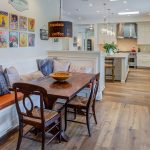 a small half wall dividing the open space between a kitchen and a farmhouse dining room