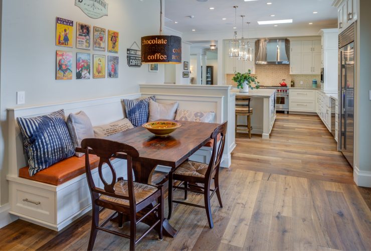 a small half wall dividing the open space between a kitchen and a farmhouse dining room