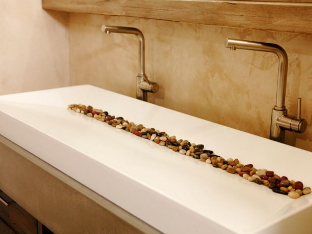 a white contemporary double-sink with colorful rocks in it