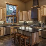 cozy contemporary kitchen with non-stained hickory cabinets and multicolor dark wood floor
