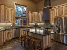 cozy contemporary kitchen with non-stained hickory cabinets and multicolor dark wood floor