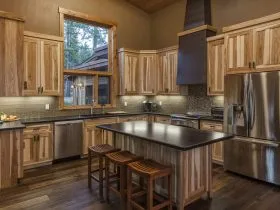 cozy contemporary kitchen with non-stained hickory cabinets and multicolor dark wood floor