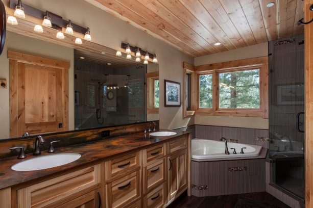 hickory cabinets and dark wood floor in a contemporary mountain style bathroom