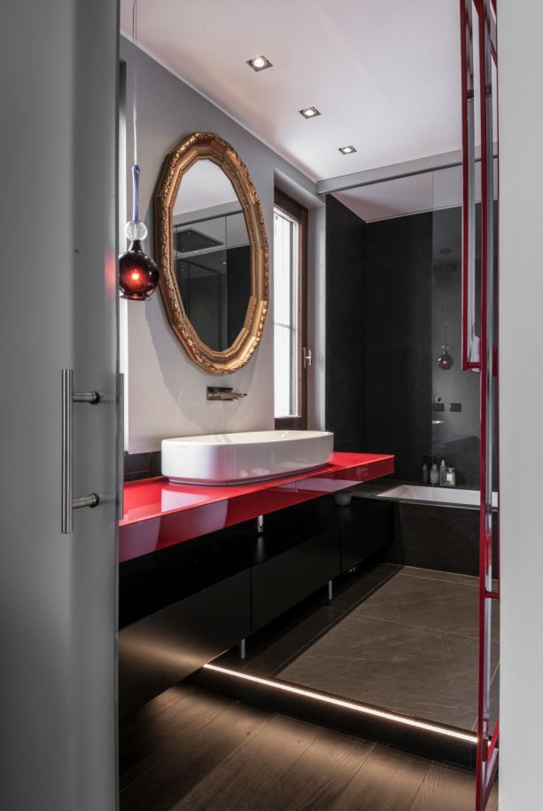 a bold contemporary red and black bathroom vanity with oversized white sink
