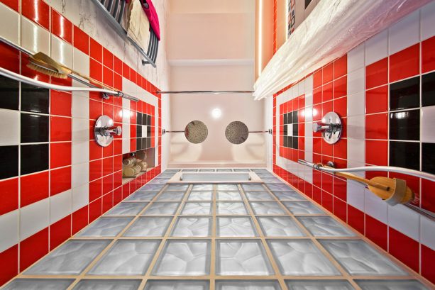 a red, black, and white shower room seen from below