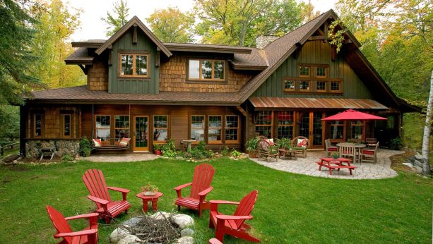 a rustic wood house with brown roof