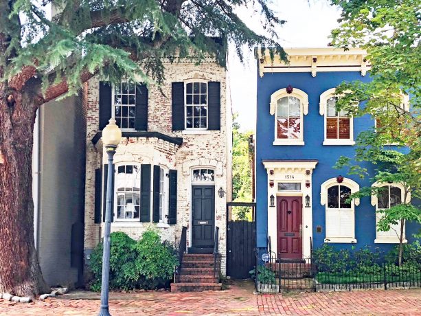 an elegant cobalt blue house with burgundy red front door