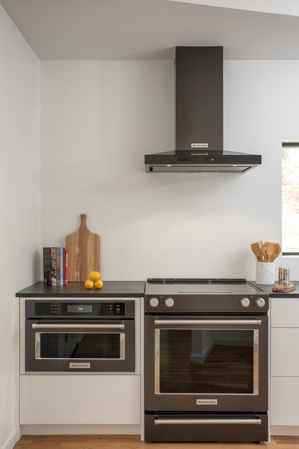 slate appliances paired with white cabinets with slate-color countertops