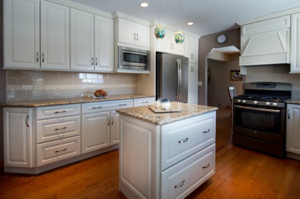 the pairing of slate appliances, white cabinets, and Cambria quartz countertops