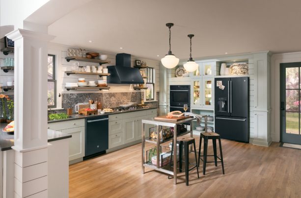 the use of complete black slate appliances, white cabinets, and black countertops in a modern kitchen