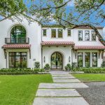 a mediterranean exterior with Tuscan white stucco wall and off-white trim