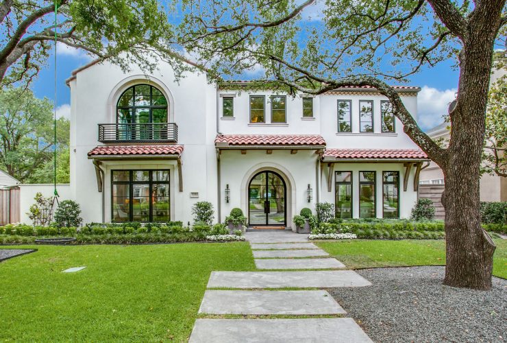a mediterranean exterior with Tuscan white stucco wall and off-white trim