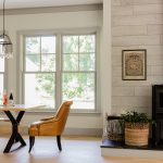a farmhouse dining room with off-white walls, grey trim, and grey windows