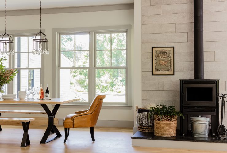 a farmhouse dining room with off-white walls, grey trim, and grey windows