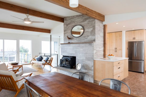 a floor-to-ceiling fireplace concealing a kitchen in a split level house