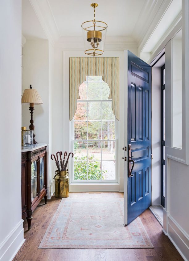 a front door with semi-glossy navy blue paint