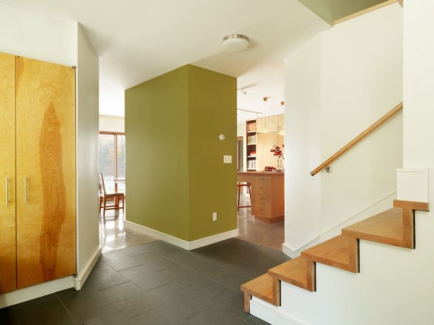 a new wall built to conceal furniture in a split-level kitchen