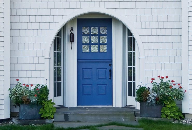 a unique entry design with navy Dutch-style front door
