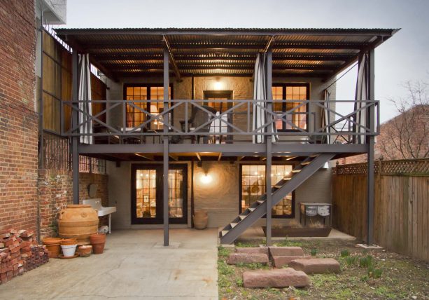 an industrial-style terrace with brick wall and corrugated metal roof