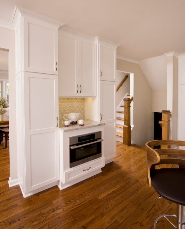 an oven and cabinets behind the middle wall