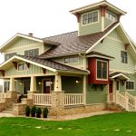 red accents in a sage green home exterior design