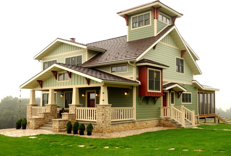 red accents in a sage green home exterior design