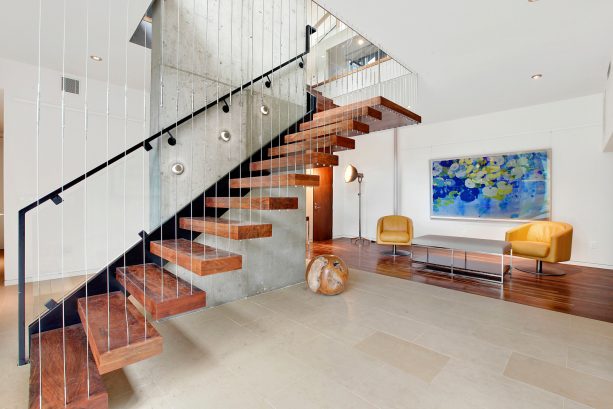 a very unique semi-floating open staircase to basement with combination of glass and cable balusters