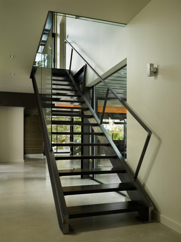 all-black open staircase design for basement area