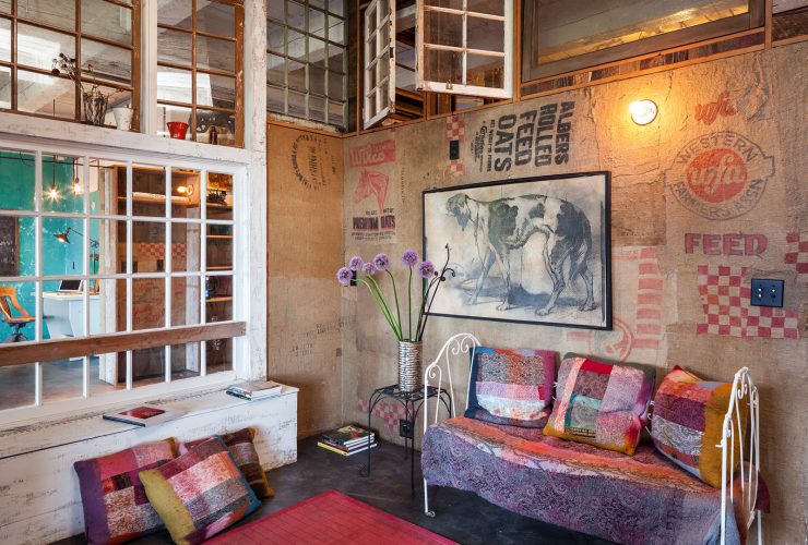 gorgeous eclectic interior with opening reclaimed windows on the upper wall