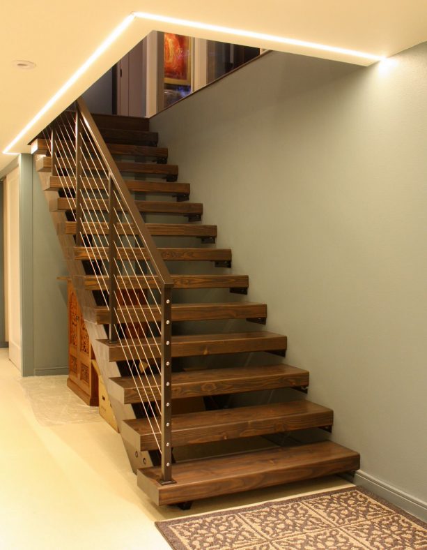 wooden open staircase with coordinating color with the metal railing