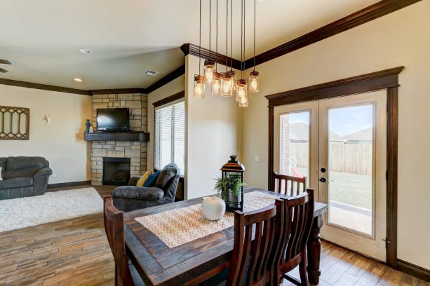 a craftsman dining room with dark brown crown molding and cream white walls