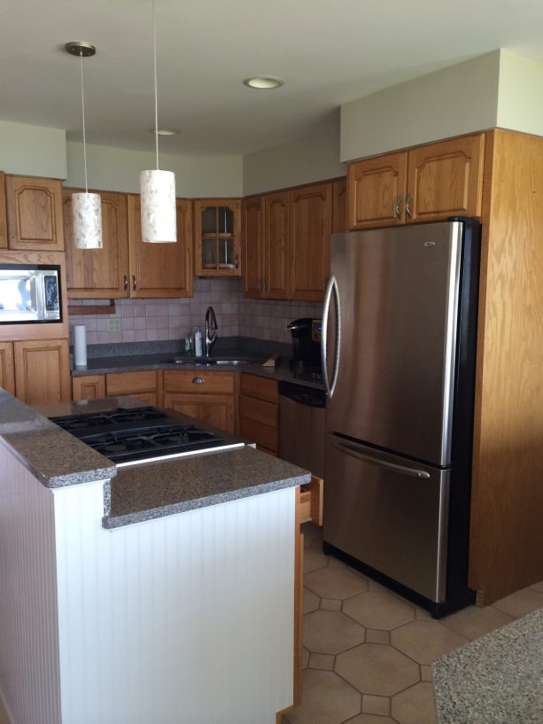 outdated honey oak cabinets in a traditional kitchen