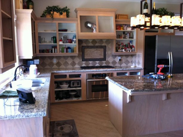 the open white-washed oak cabinets look untidy before the update