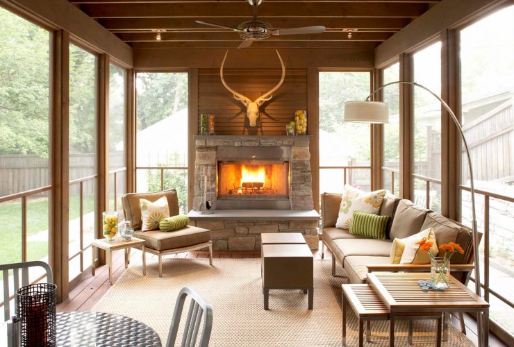 a small rustic screened porch with full decorations that makes it looks like a real living room