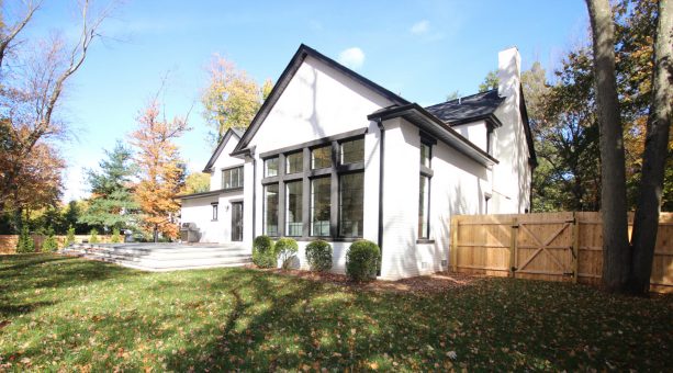 charcoal grey trim for a white brick house