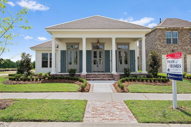 coordinating grey windowed-doors and trim in a traditional white home exterior design