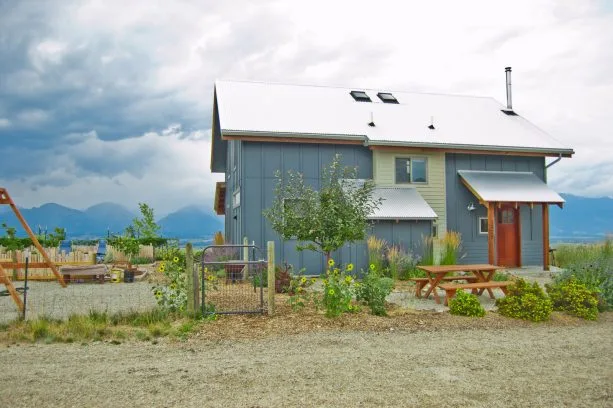 a dark blue with grey undertone exterior of a farmhouse-style mountain home
