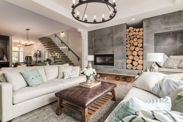 a farmhouse industrial living room interior with wall-size unfinished concrete fireplace