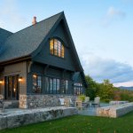 a gorgeous dark brown house looks like it belongs to the mountain area