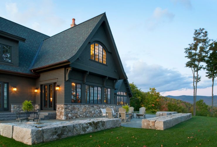a gorgeous dark brown house looks like it belongs to the mountain area