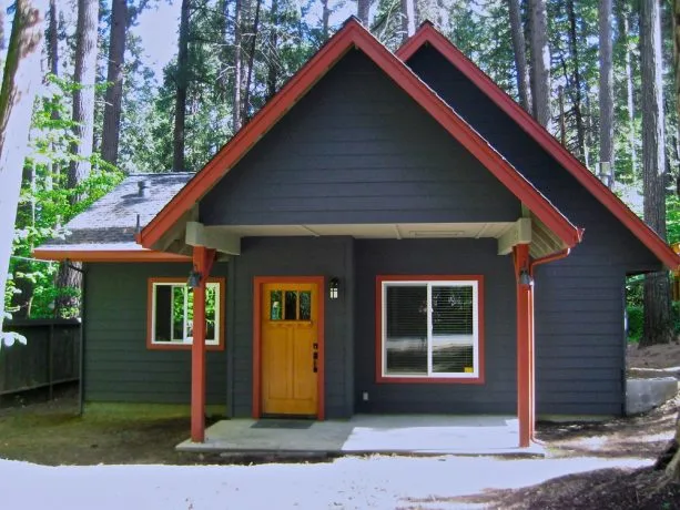 a grey-navy mountain home exterior with red trim