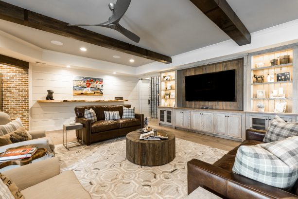a living room interior with industrial farmhouse style and exposed wood beams as one of the attention-stealer
