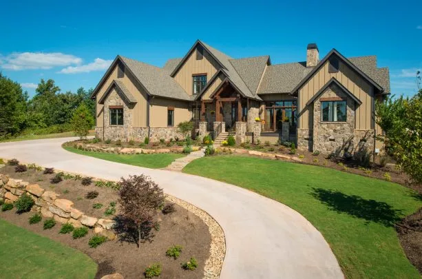 a rustic mountain home exterior with tan-painted siding