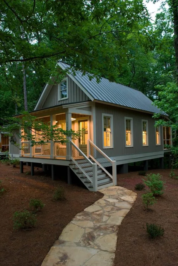 a small grey mountain home with bone white trim